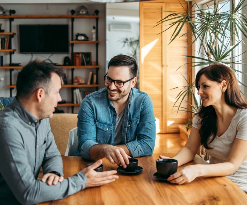 three workmates in discussion at staff room